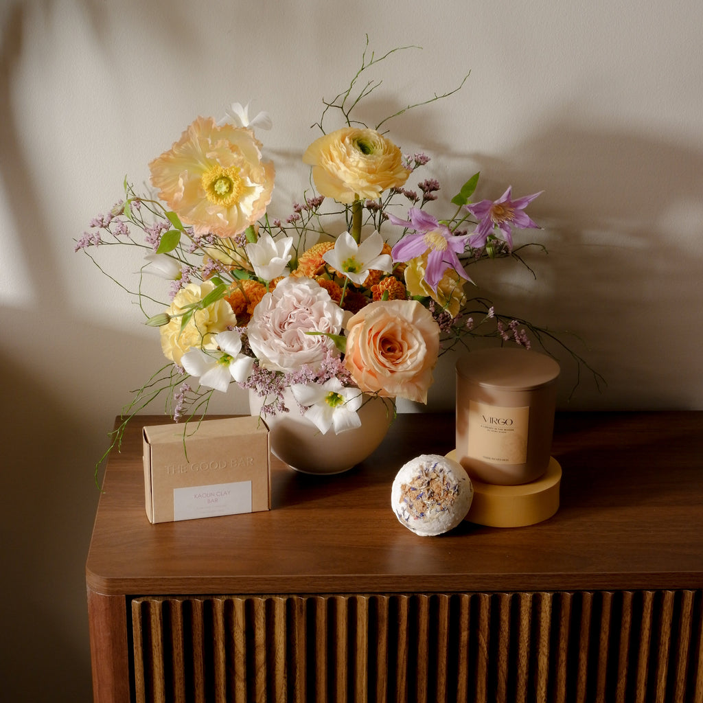 Seasonal flower arrangement with candle and objects Toronto Hunt & Gather